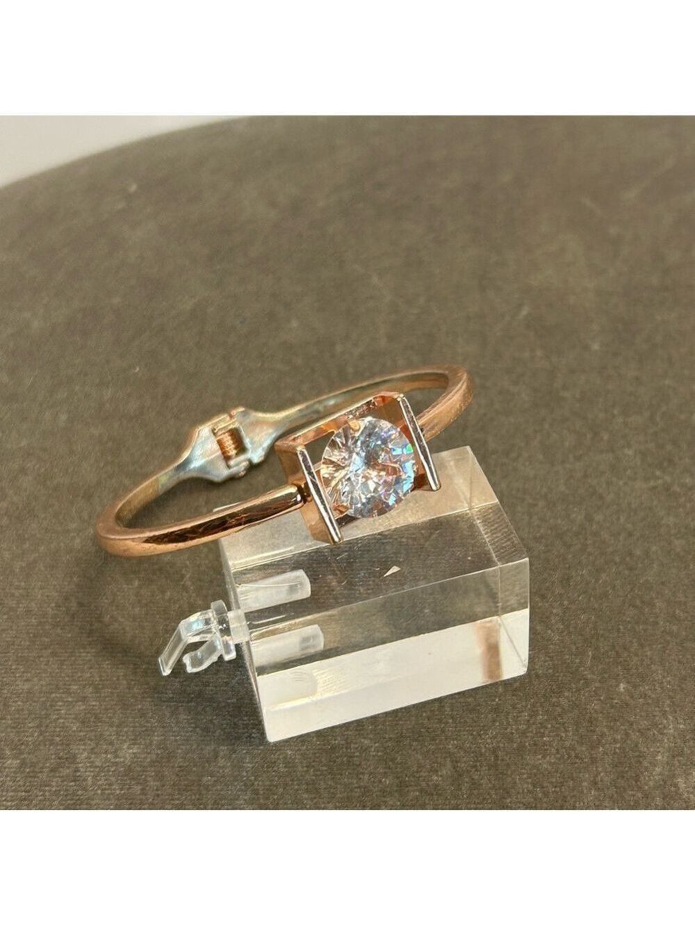 bracelet featuring large round clear gemstone set within square open-sided frame